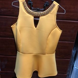 Yellow sleeveless top with flounce bottom
